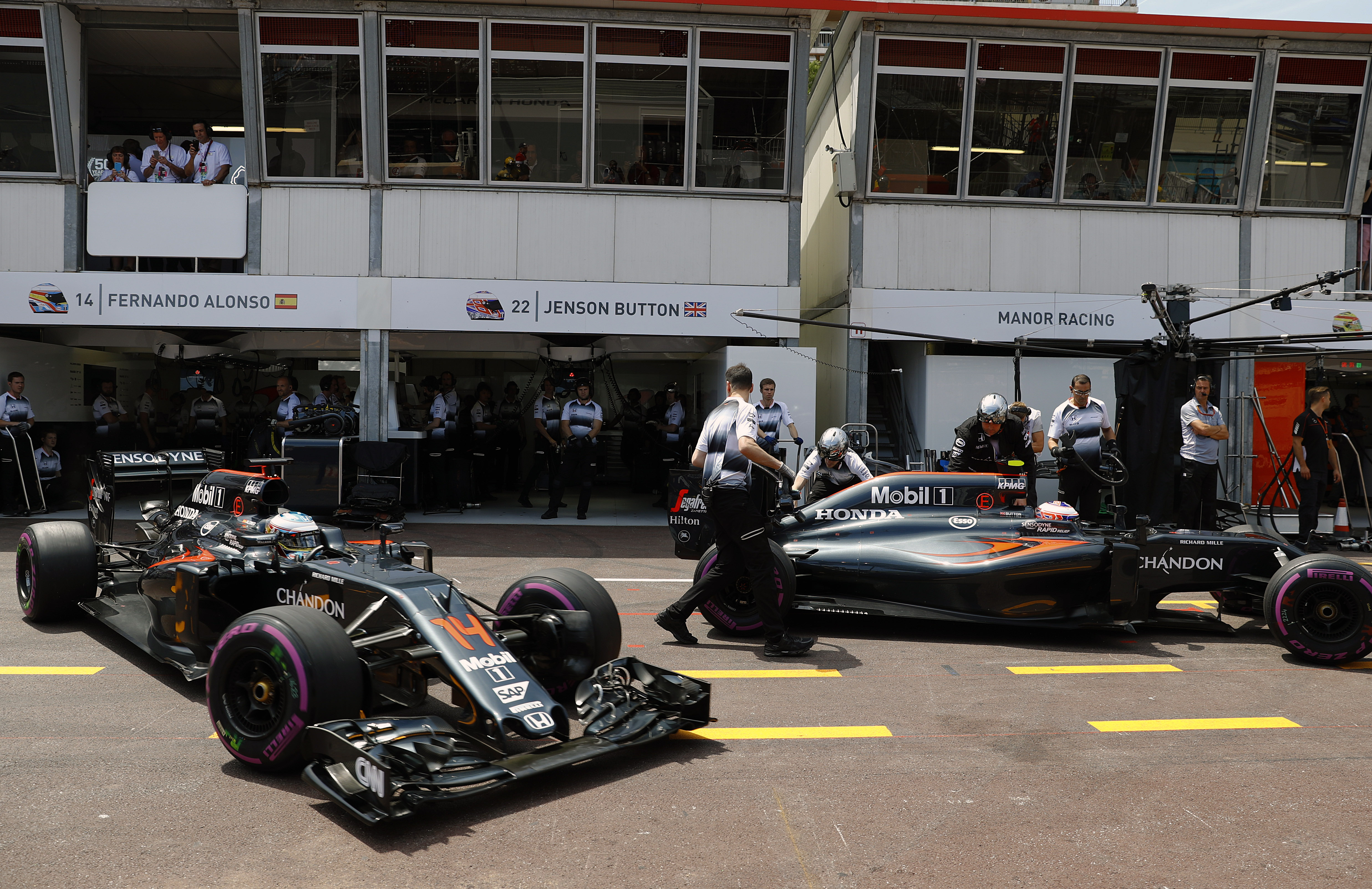 Fernando Alonso and Jenson Button in the pits.