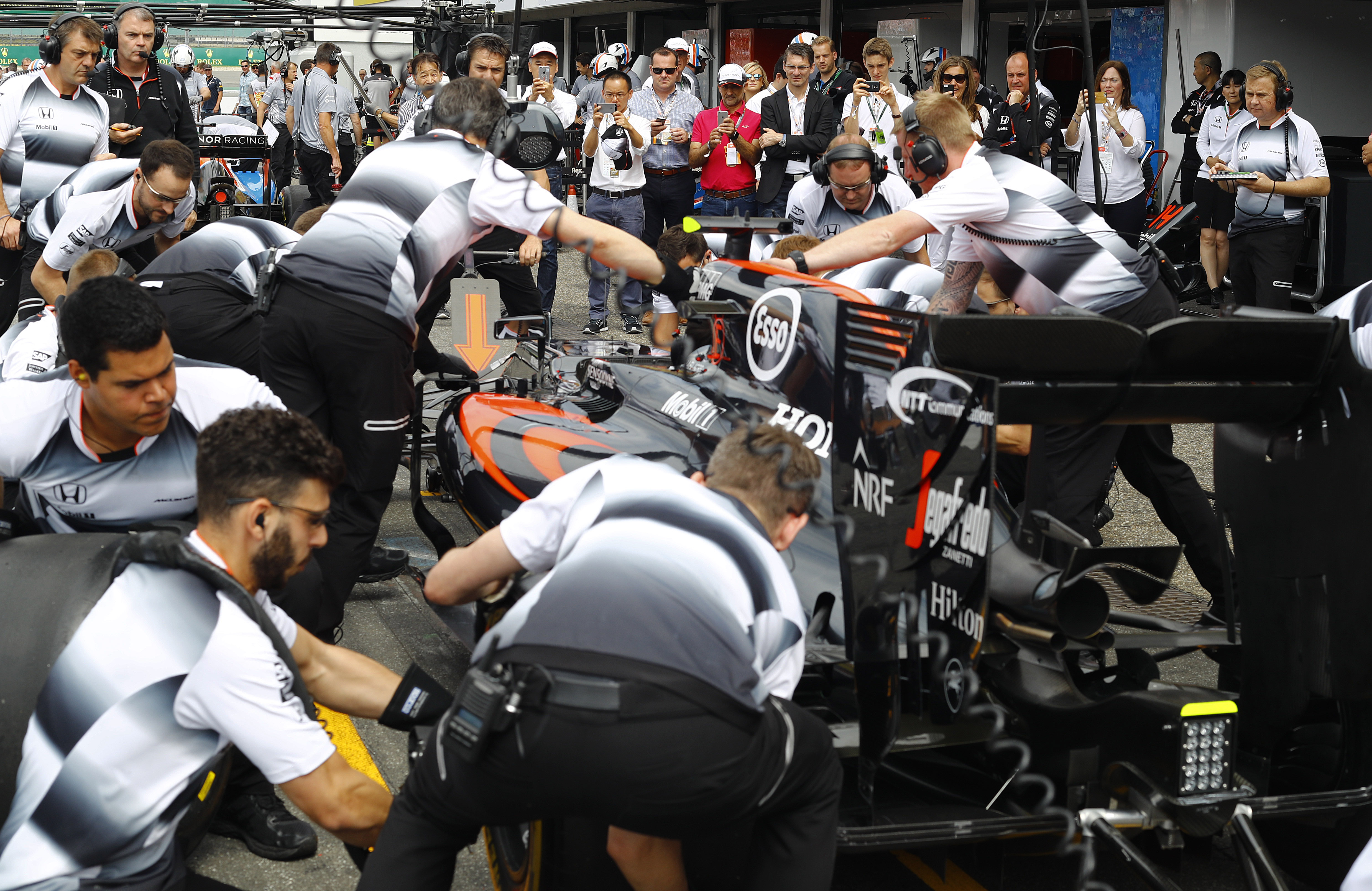 The McLaren team conduct a practice pit stop.